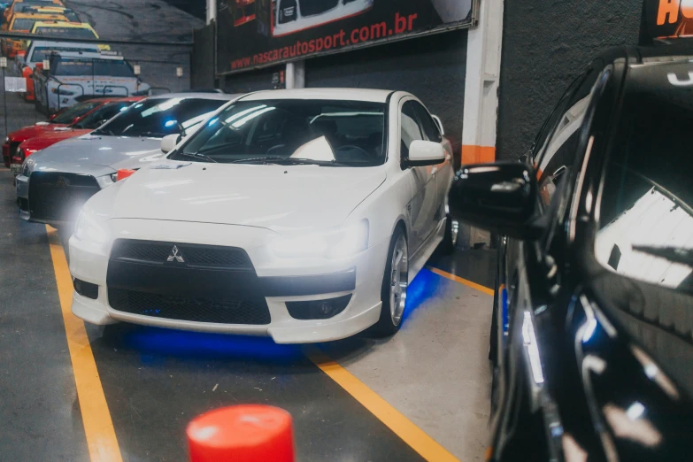 a white car parked in a parking garage, a hologram, by Felipe Seade, unsplash, in sao paulo, avatar image, tokyo drift, sport car