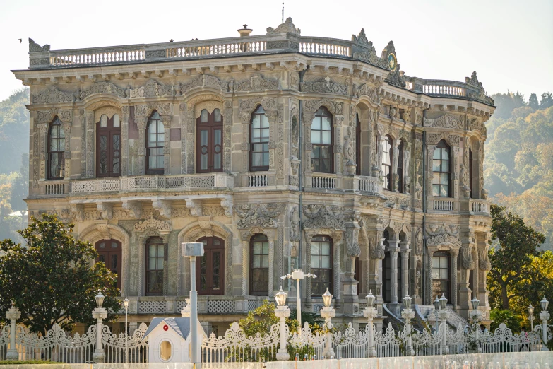 a large building sitting on the side of a road, a marble sculpture, inspired by Nadim Karam, pexels contest winner, baroque, turkey, victorian house, exterior botanical garden, viewed from the ocean