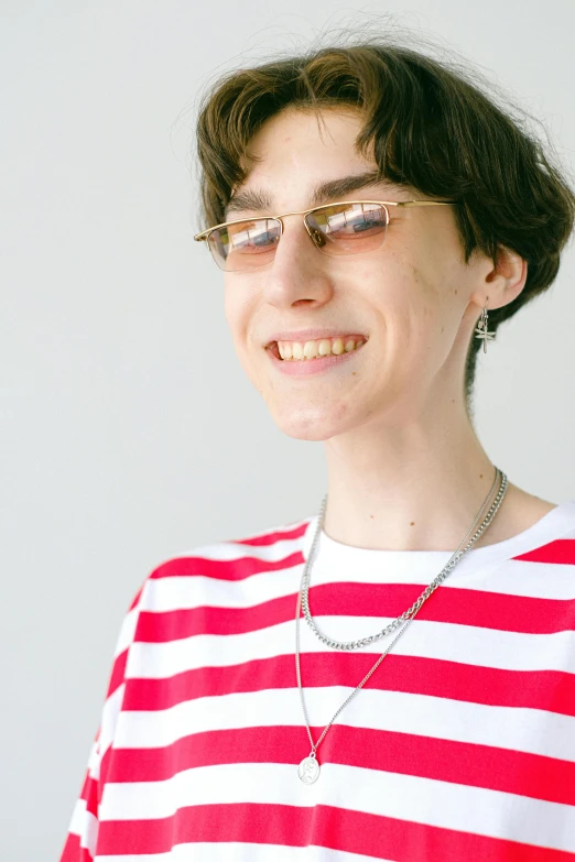 a woman wearing glasses and a red and white striped shirt, an album cover, inspired by Jean Malouel, featured on reddit, halfbody headshot, high resolution photo, androgynous person, very sunny