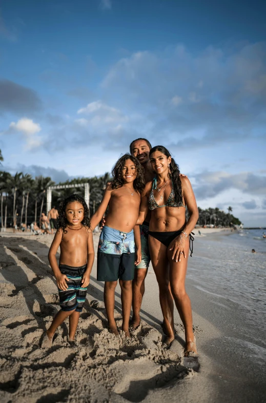 a group of people standing on top of a sandy beach, jason momoa, happy family, standing on a beach in boracay, f / 4