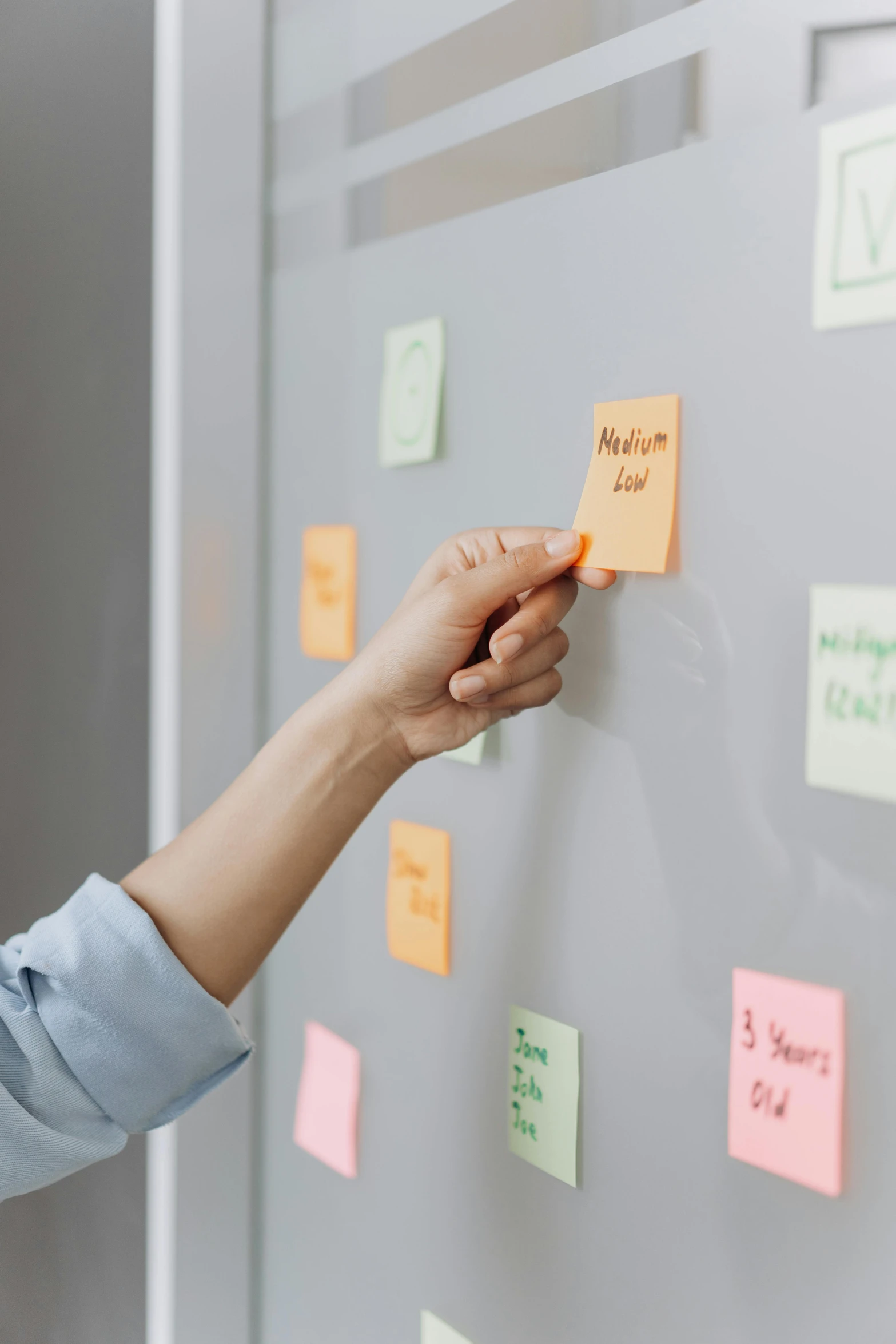 a woman standing in front of a whiteboard covered in post it notes, a close up shot, hand, centered design, thumbnail