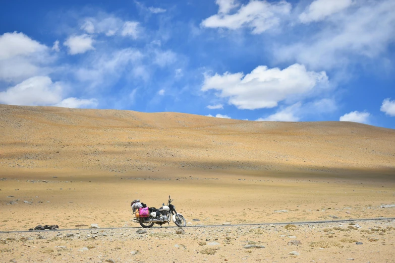 a couple of people riding on the back of a motorcycle, by Thomas Barker, pexels contest winner, hurufiyya, serene vast landscape, avatar image, an exhausted deity, ground - level medium shot