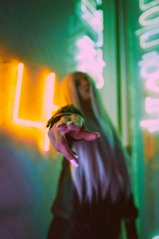 a person standing in front of a neon sign, cyberpunk art, inspired by Elsa Bleda, unsplash, billie eilish as a nun, forming a burning hand spell, discreet lensflare, with long white hair