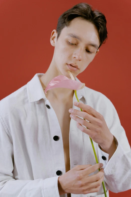 a man in a white shirt holding a pink flower, inspired by Yanjun Cheng, aestheticism, non binary model, with a straw, jelly, alessio albi and shin jeongho