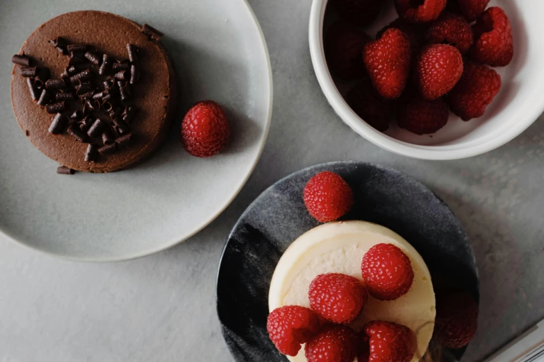 a dessert sitting on top of a plate next to a bowl of strawberries, unsplash, raspberries, round cheeks, background image