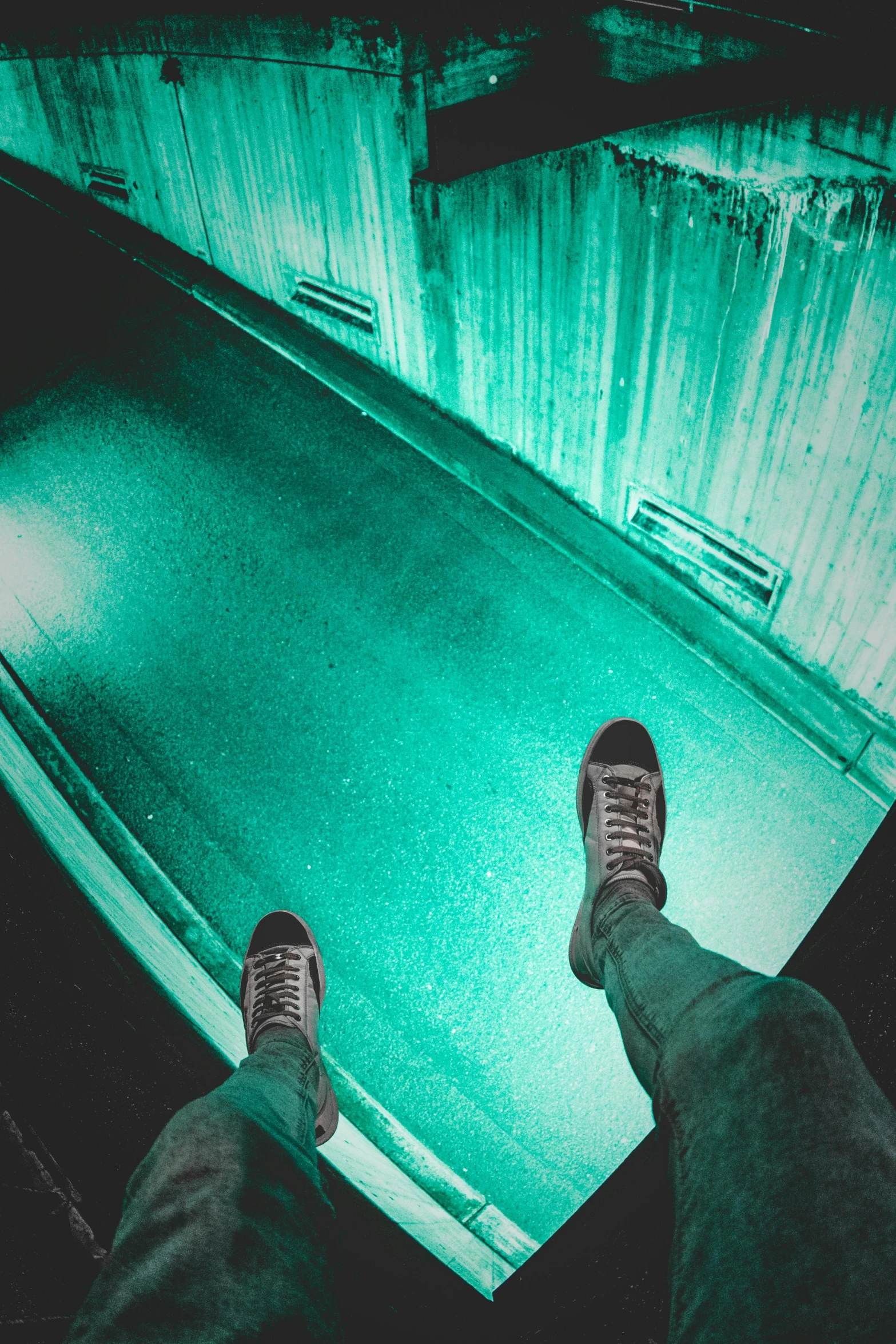 a person standing on top of a glass floor, inspired by Elsa Bleda, pexels contest winner, green scary lights, pewdiepie selfie at a bridge, sneaker photo, cyan dimensional light