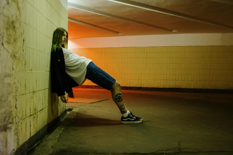 a person leaning against a wall with a skateboard, inspired by Elsa Bleda, scary pose, stood in a tunnel, profile image, 90s photo