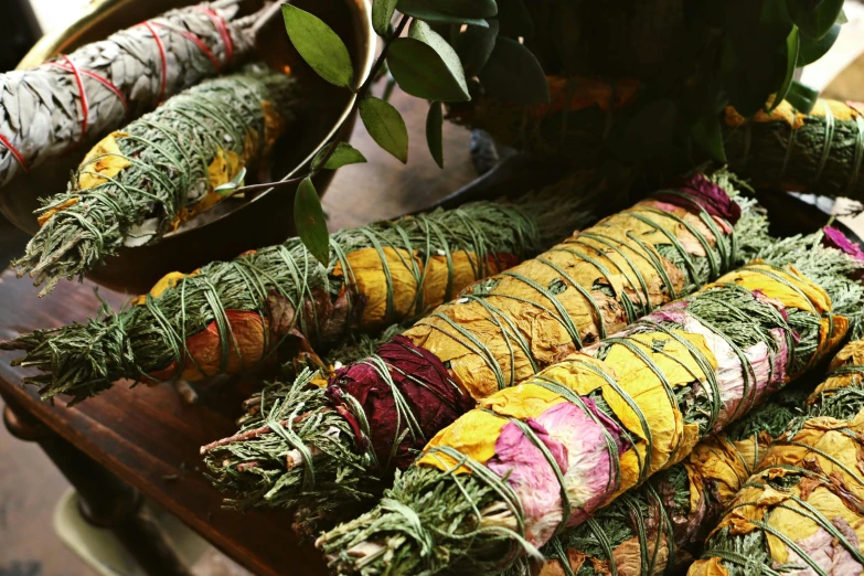 a bunch of herbs sitting on top of a wooden table, colorful robes, carefully crafted, healing tubes, vibrantly lush
