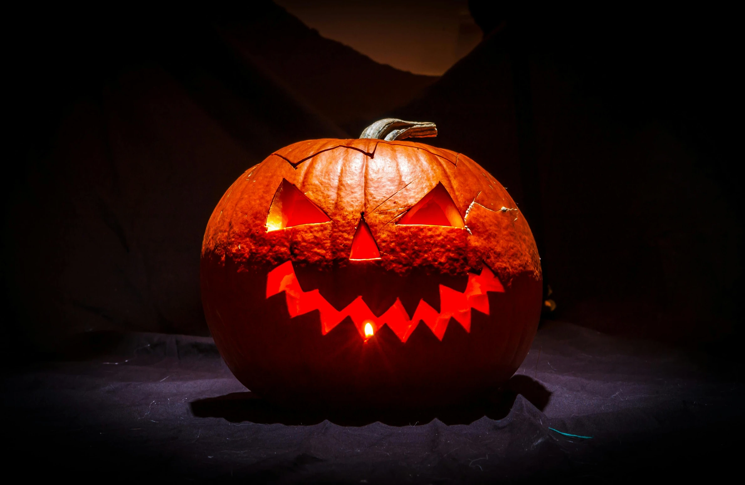 a carved pumpkin sitting on top of a table, pexels, eery light, slide show, lantern, low iso