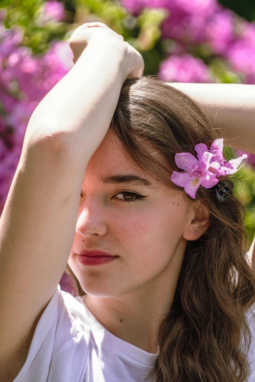 a girl with a flower in her hair, trending on unsplash, overgrown with orchids, dua lipa, in the sun, young southern woman