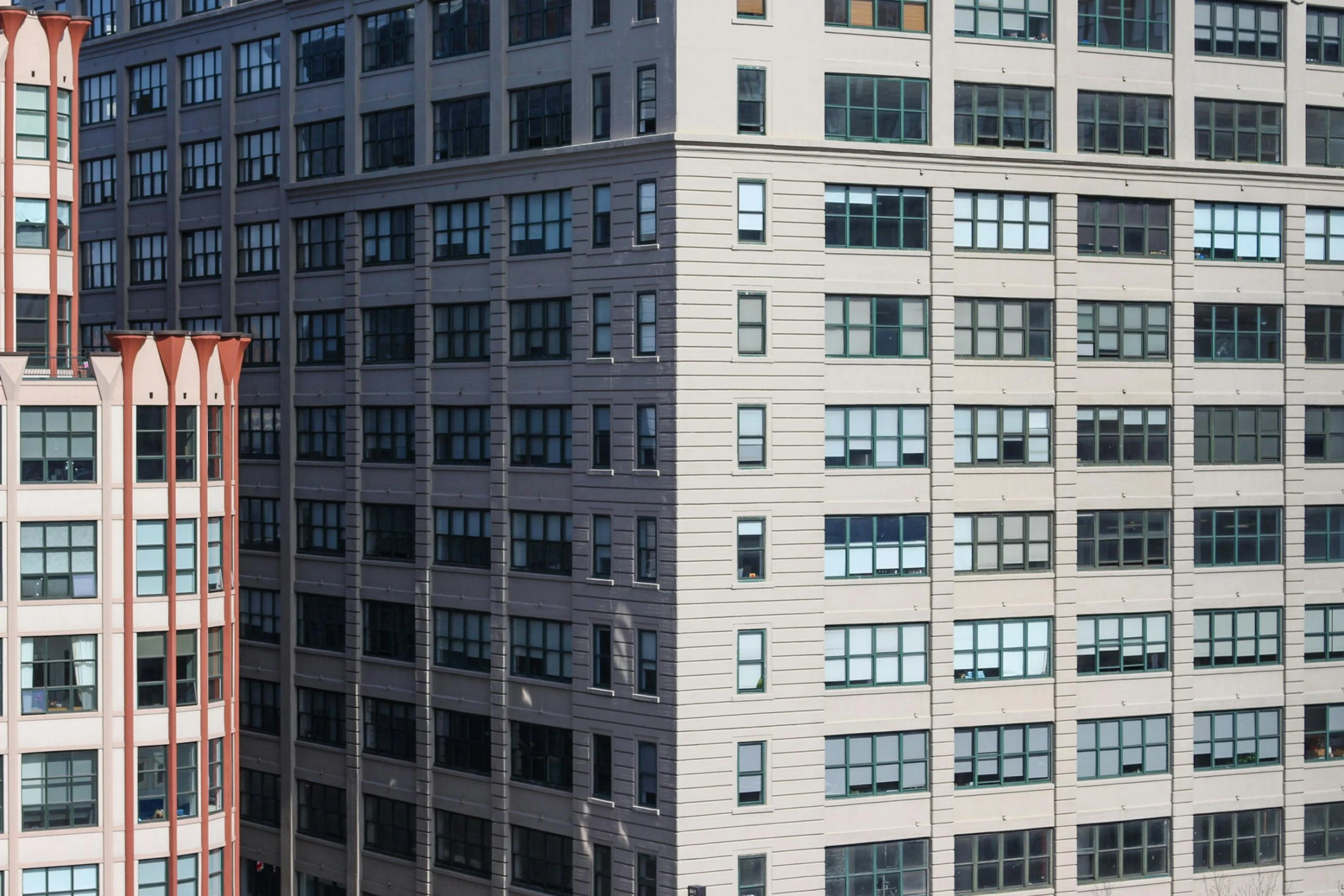 a couple of tall buildings next to each other, a photo, inspired by Donald Judd, unsplash, payne's grey and venetian red, high angle close up shot, ignant, gigapixel photo