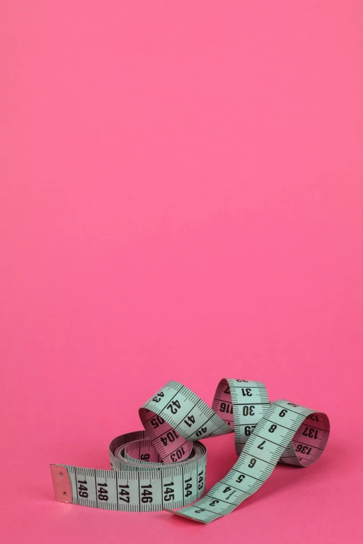 a measuring tape on a pink background, by Olivia Peguero, obese ), photograph”