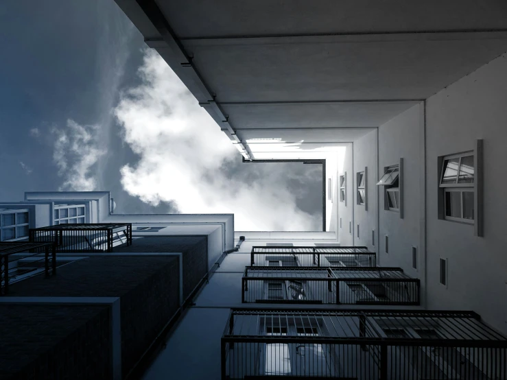 a very tall building with a lot of windows, a matte painting, inspired by Leandro Erlich, unsplash contest winner, bauhaus, volumetric smoke, view from inside, ignant, misty alleyways