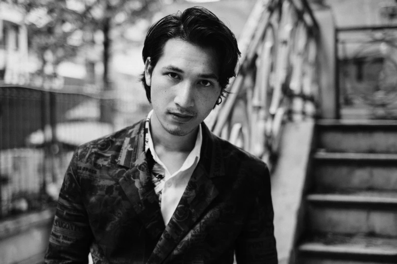 a black and white photo of a man in a suit, a black and white photo, tumblr, shin hanga, he looks like tye sheridan, omar shanti himalaya tibet, promotional portrait, zaha hadi