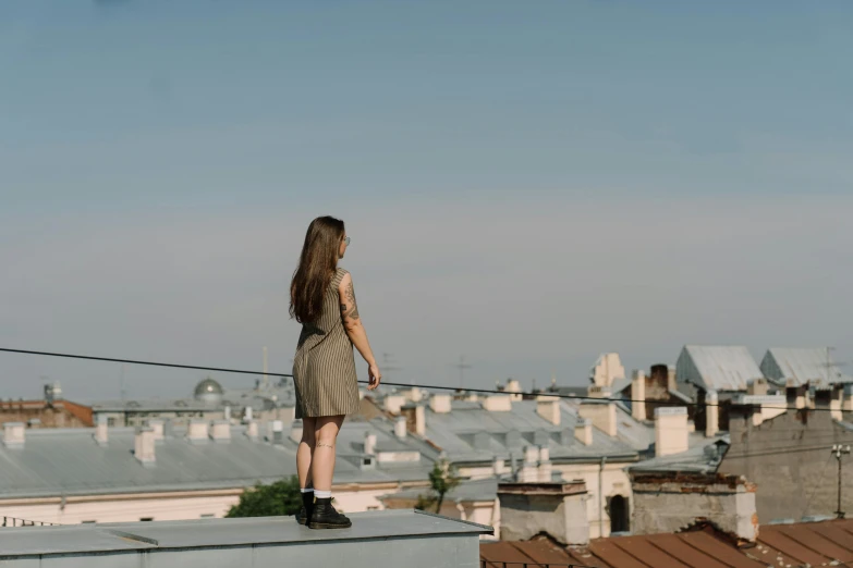 a woman standing on the roof of a building, by Attila Meszlenyi, pexels contest winner, happening, girl with brown hair, 15081959 21121991 01012000 4k, in full growth from the back, low quality photo