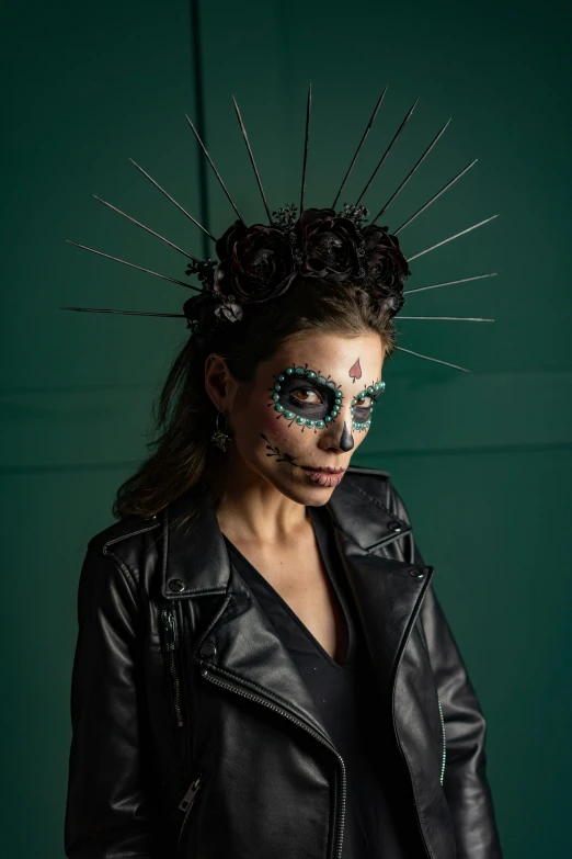 a woman in a black leather jacket with spikes on her head, inspired by Kahlo, trending on pexels, international gothic, dia de muertos dress and make up, black and teal paper, frontal pose, spines