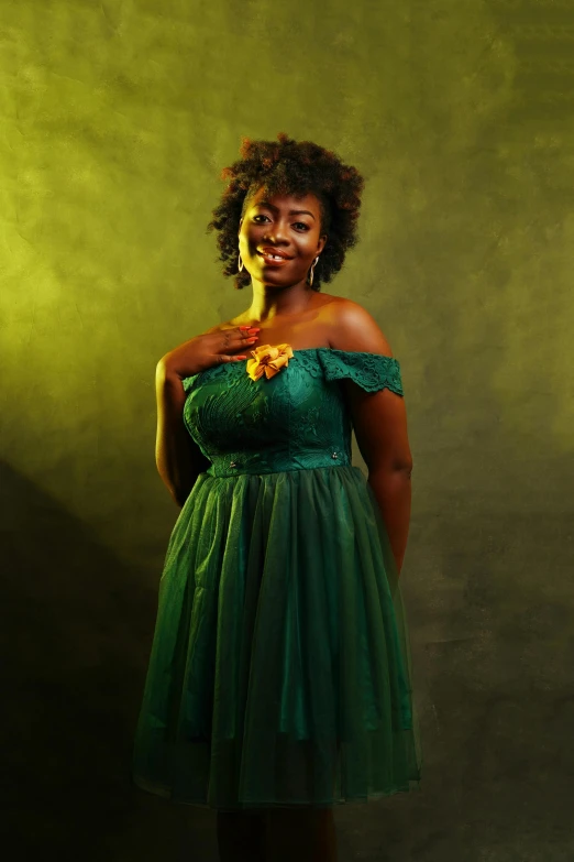 a woman in a green dress posing for a picture, an album cover, by Chinwe Chukwuogo-Roy, pexels contest winner, dark skin tone, with a happy expression, golden glow, voluminous