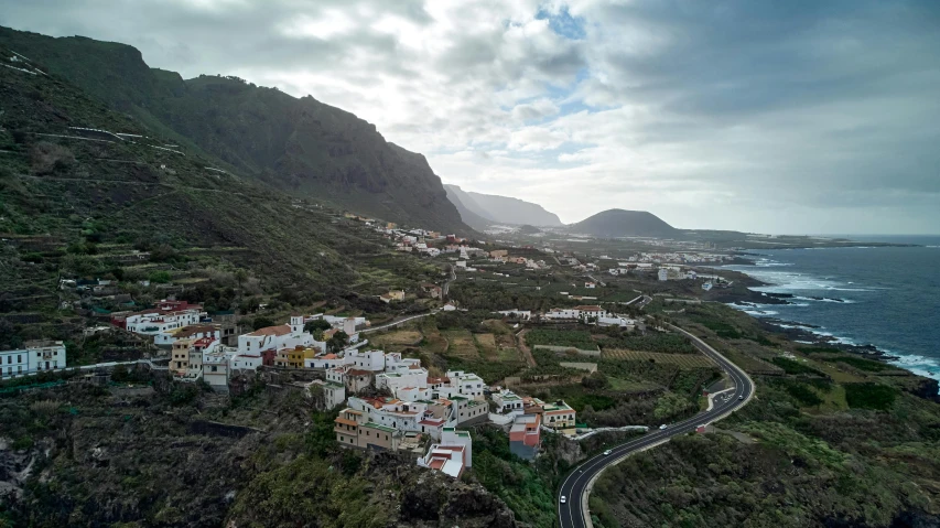 an aerial view of a small town next to the ocean, by Daniel Lieske, pexels contest winner, overlooking a valley, spanish, slide show, square