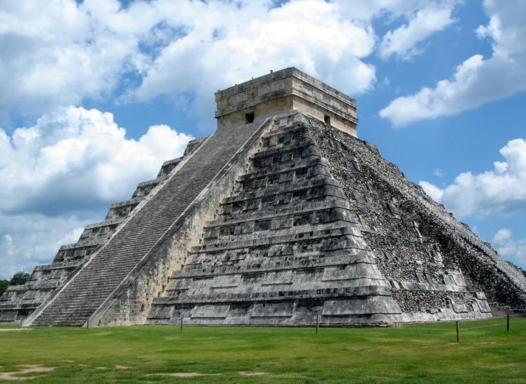 a large pyramid sitting on top of a lush green field, aztec architecture, avatar image
