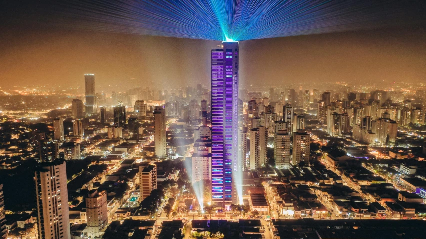 a tall building in the middle of a city at night, by Matteo Pérez, purple laser lighting, colombia, that is 1300 feet tall, octa 8k