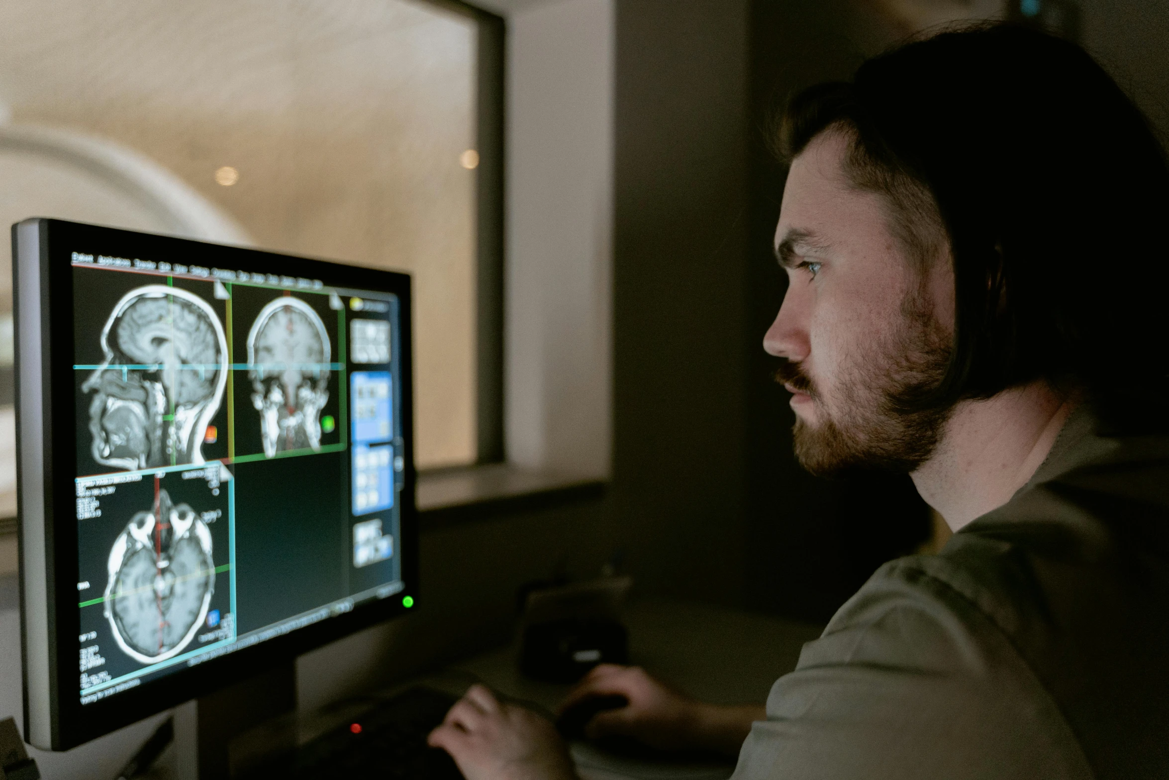 a man sitting in front of a computer monitor, pexels contest winner, mri, neurograph, instagram post, brown