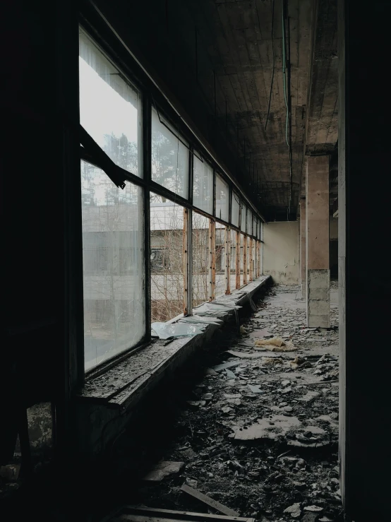 a black and white photo of the inside of a building, inspired by Elsa Bleda, unsplash contest winner, brutalism, nuclear aftermath, space seen outside from a window, color photo, ground level view of soviet town