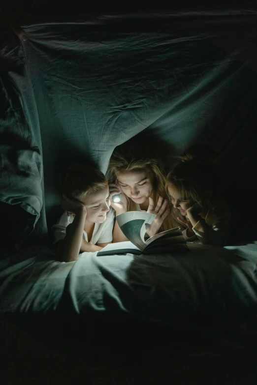 a woman reading a book in bed under a blanket, a portrait, unsplash contest winner, group of people in a dark room, ignant, teenager, high angle