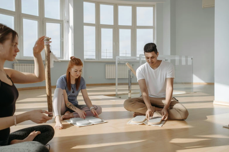 a group of people sitting on the floor doing yoga, academic art, thumbnail, abcdefghijklmnopqrstuvwxyz, roleplaying, in a room