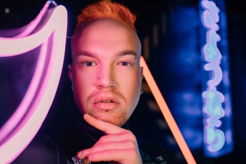 a man standing in front of a neon sign, an album cover, inspired by David LaChapelle, trending on pexels, ru paul\'s drag race, holding trident, closeup portrait shot, julian ope