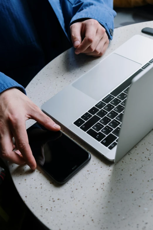 a person sitting at a table with a laptop and cell phone, pexels, curated collections, grey, maintenance, thumbnail