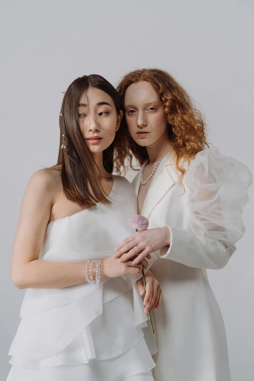 a couple of women standing next to each other, inspired by Wang Duo, trending on pexels, renaissance, wearing a white tuxedo, wearing jewellery, pale skin, lookbook