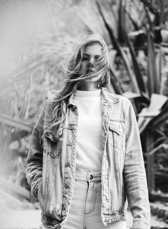 a black and white photo of a woman with long hair, pexels contest winner, wearing a jeans jackets, sydney sweeney, white clothing, chillwave