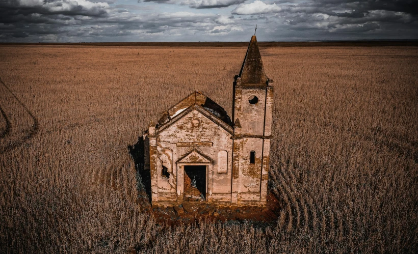an old church in the middle of a wheat field, pexels contest winner, renaissance, erosion, kris kuksi, a high angle shot, annie liebowitz