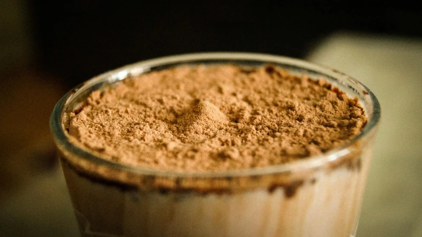 a close up of a cup of coffee on a table, powder, detailed product image, fan favorite, edible