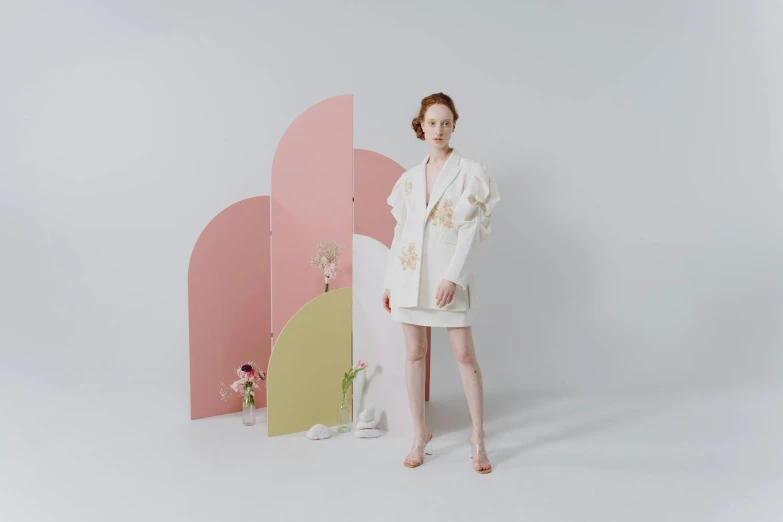 a woman standing in front of a pink and yellow wall, inspired by Hsiao-Ron Cheng, rococo, wearing lab coat and a blouse, on white background, made of silk paper, short skirt and a long jacket