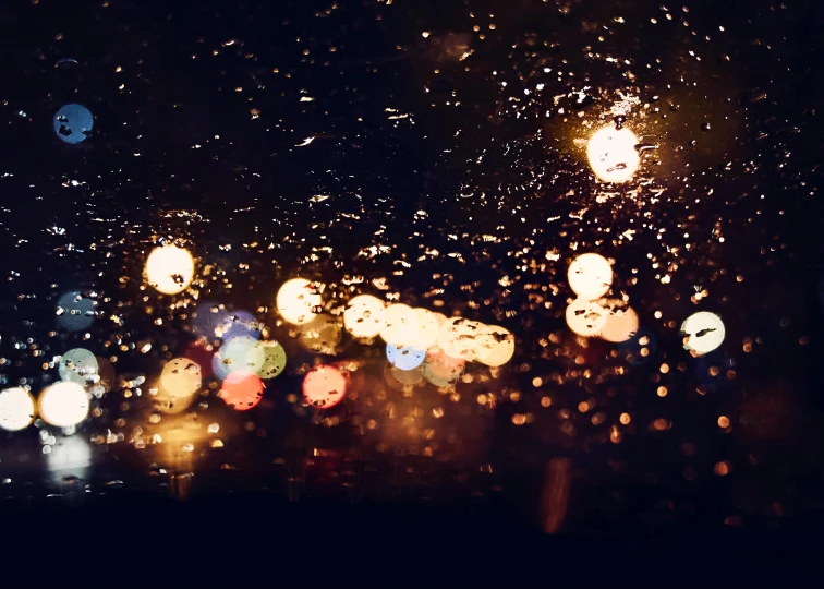 a blurry picture of a city at night, unsplash, visual art, raindrops, viewed through the cars window, sparkles and glitter, autumn rain turkel