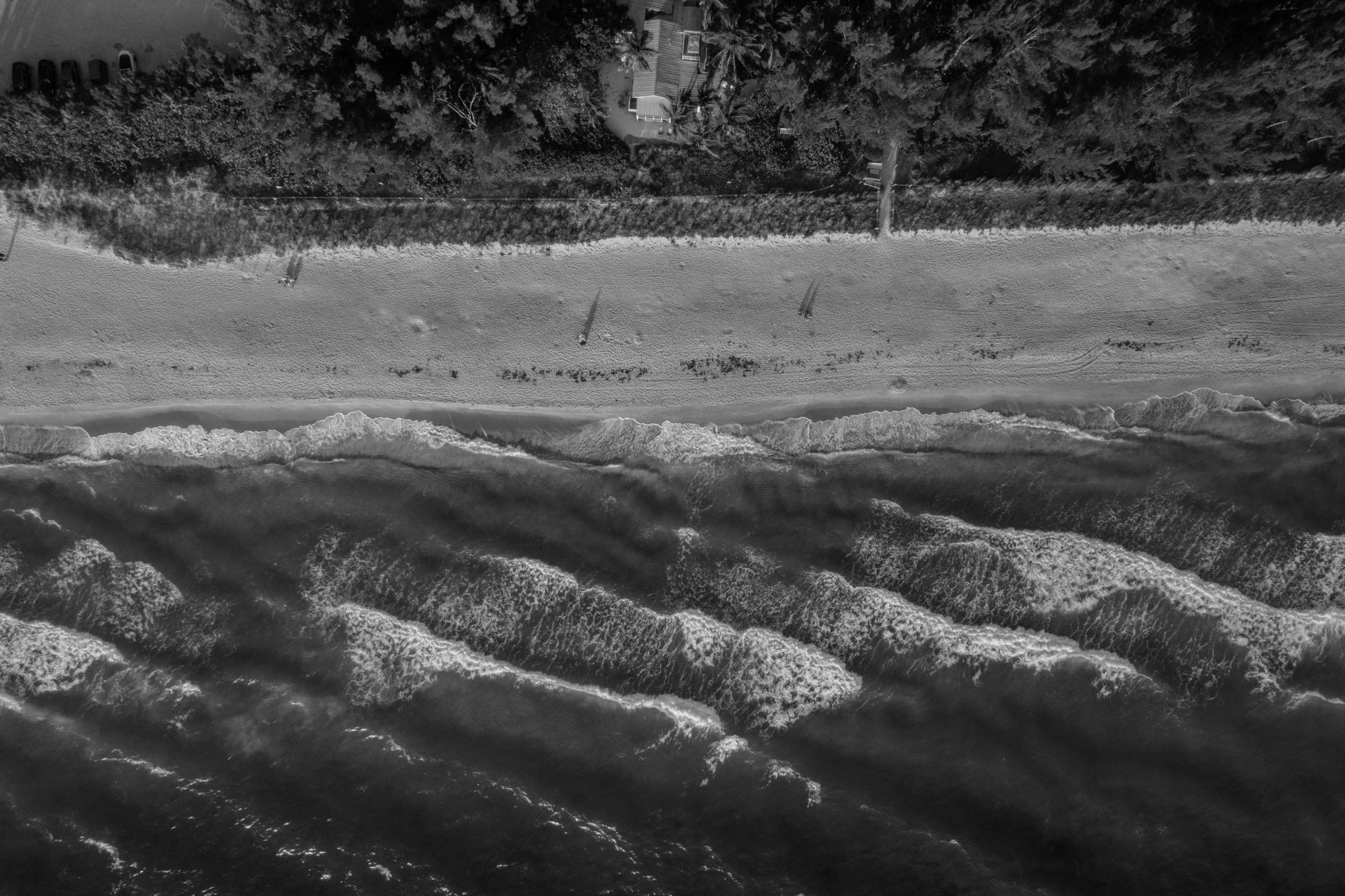 a black and white photo of a beach, a black and white photo, by Jan Rustem, unsplash, surrealism, top - down photo, river rapids, warsaw, standing near the beach