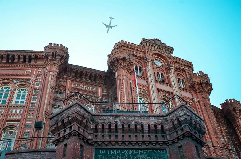 a large building with a plane flying over it, inspired by Wes Anderson, pexels contest winner, art nouveau, kazakh empress, the red citadel, buenos aires, thumbnail