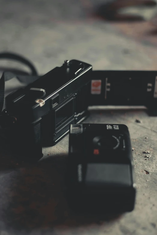 a camera sitting on top of a wooden table, film artifacts, switch, unsplash photography, grainy footage