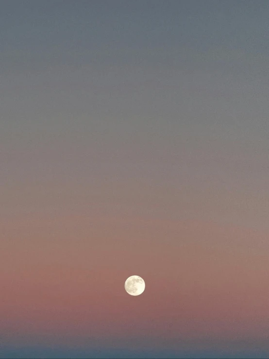 a full moon is rising over the ocean, unsplash, minimalism, faded pink, ffffound, instagram story, pale beige sky