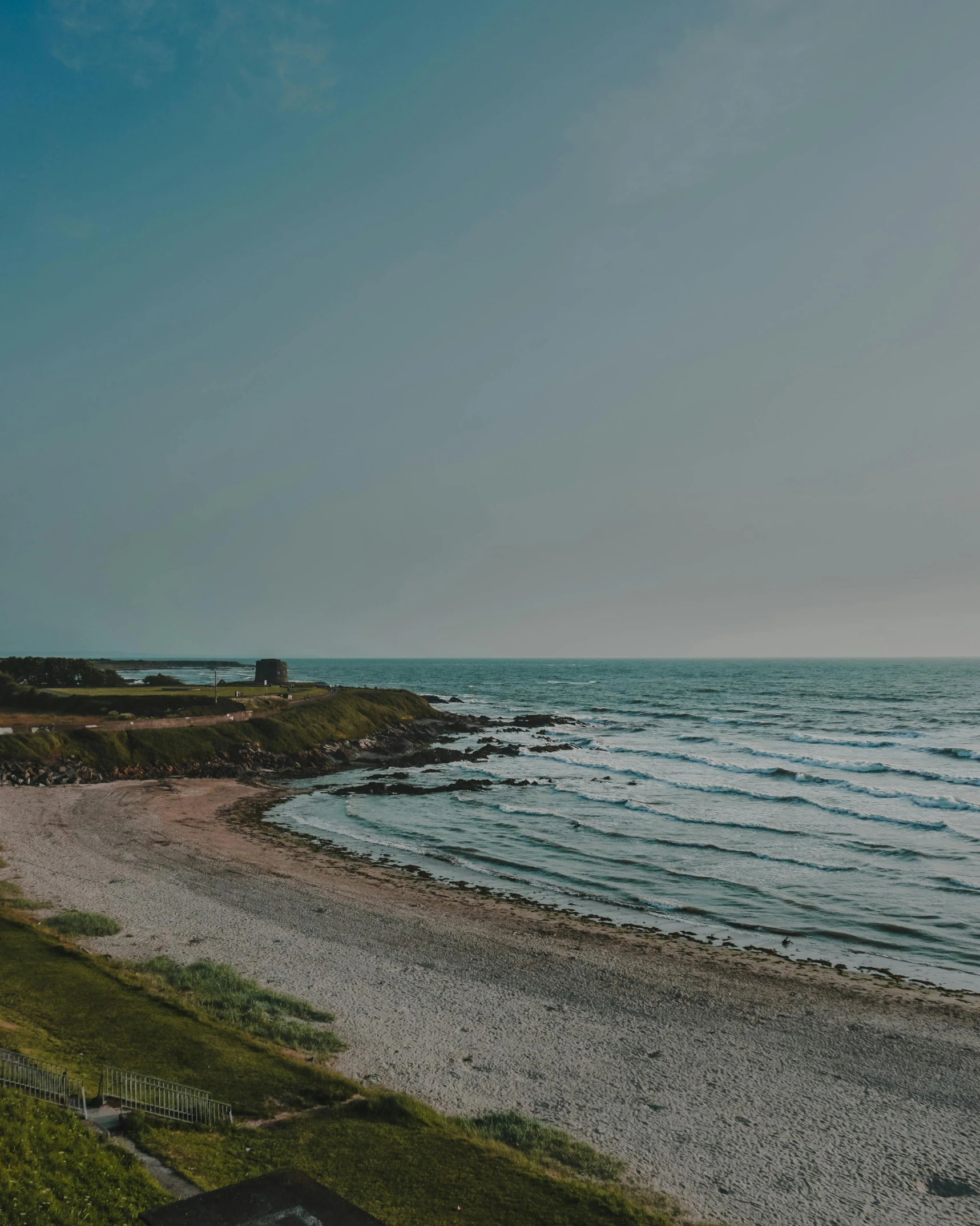 a view of a beach from the top of a hill, pexels contest winner, hammershøi, maryport, low quality photo, background image