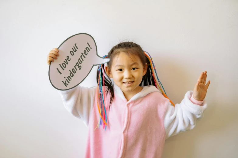 a little girl that is holding up a sign, inspired by Kun Can, pexels contest winner, speech bubbles, 15081959 21121991 01012000 4k, half asian, color photograph portrait 4k