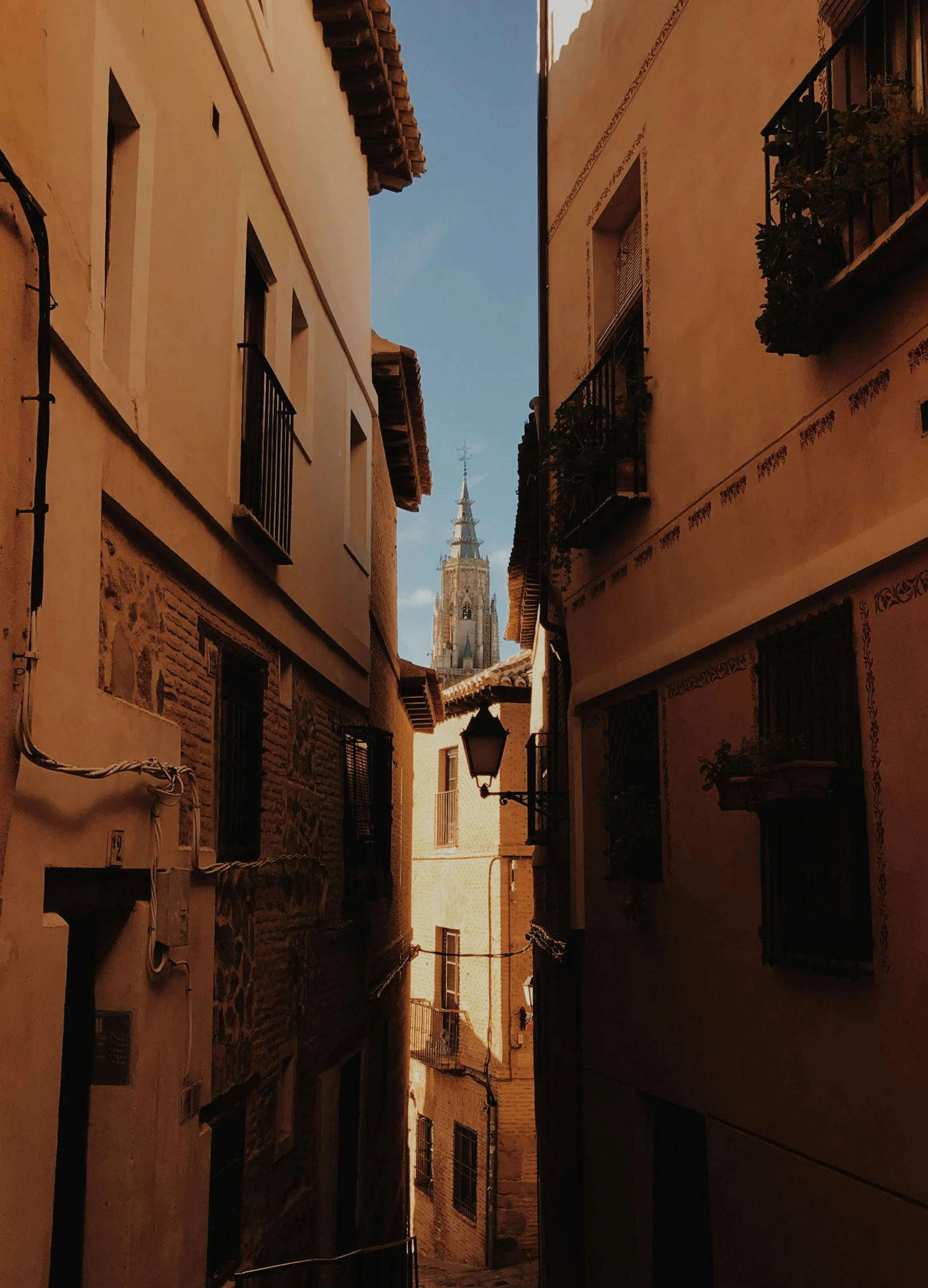 a narrow alley with a clock tower in the background, inspired by Luis Paret y Alcazar, pexels contest winner, towering high up over your view, beige, bright ”