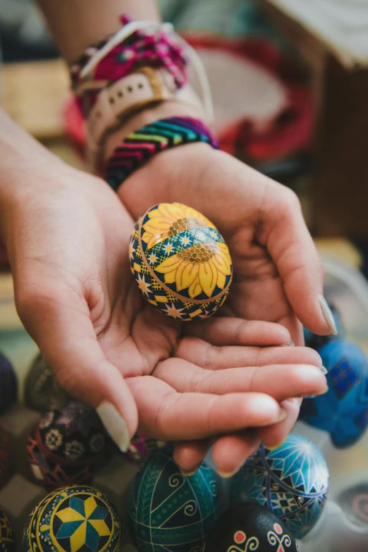 a person holding a bunch of eggs in their hands, by Maksimilijan Vanka, pexels contest winner, renaissance, cloisonne, square, hippie, rock painting