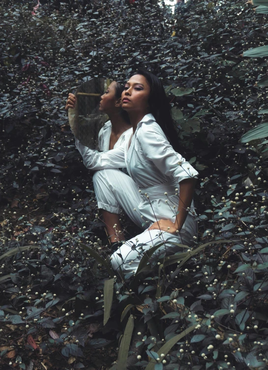 a woman sitting on top of a pile of leaves, an album cover, unsplash, aestheticism, wearing white pajamas, in a jungle environment, bella poarch, badass pose