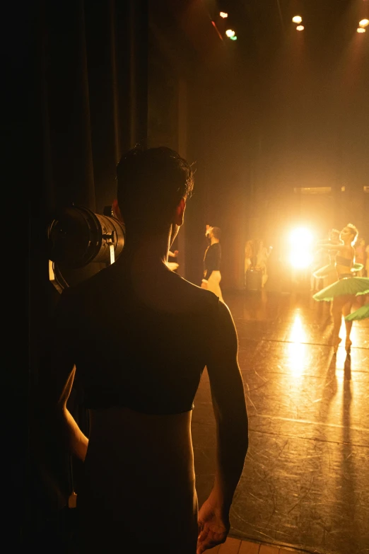 a group of people standing on top of a stage, by David Donaldson, trending on unsplash, ballet dancer, back light, male model, ( ( theatrical ) )