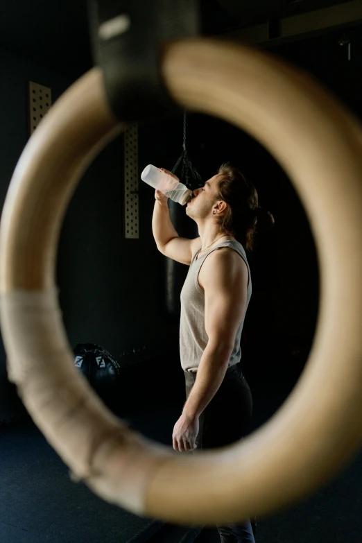 a man drinking from a bottle in a gym, pexels contest winner, renaissance, male with halo, gif, lachlan bailey, profile image