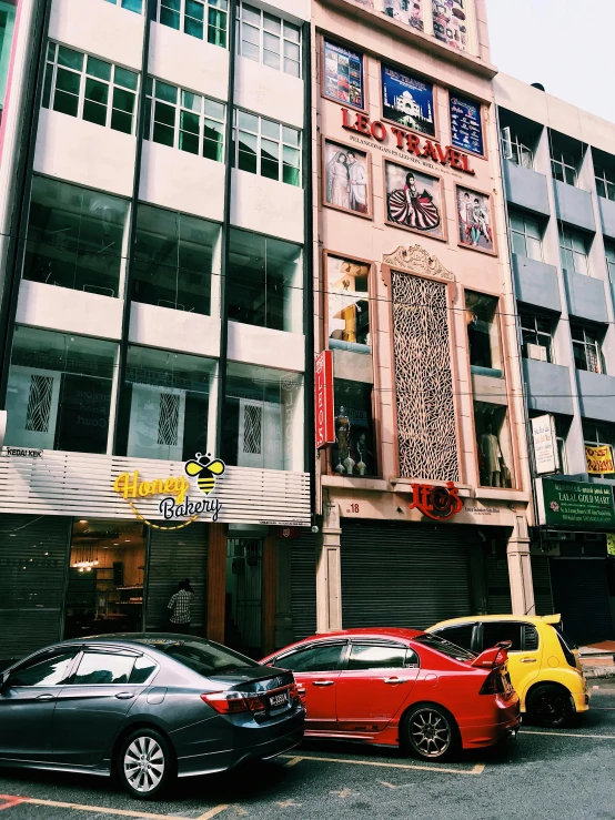 a group of cars parked in front of a building, by Adam Rex, pexels contest winner, kuala lumpur, shop front, snapchat photo, singapore ( 2 0 1 8 )