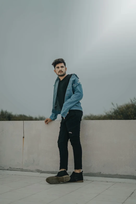 a man riding a skateboard on top of a cement wall, an album cover, by Adam Dario Keel, aestheticism, wearing a jeans jackets, profile image, wearing a track suit, profile pic