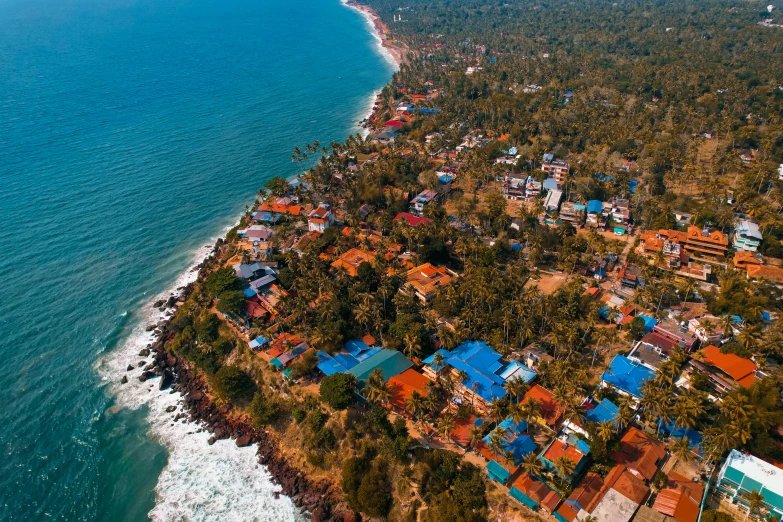 a large body of water next to a beach, by Max Dauthendey, pexels contest winner, hurufiyya, above a village, hyperdetailed colourful, kerala village, view of the ocean